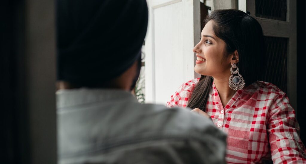 A cheerful couple enjoying a moment at home, showcasing culture and love.